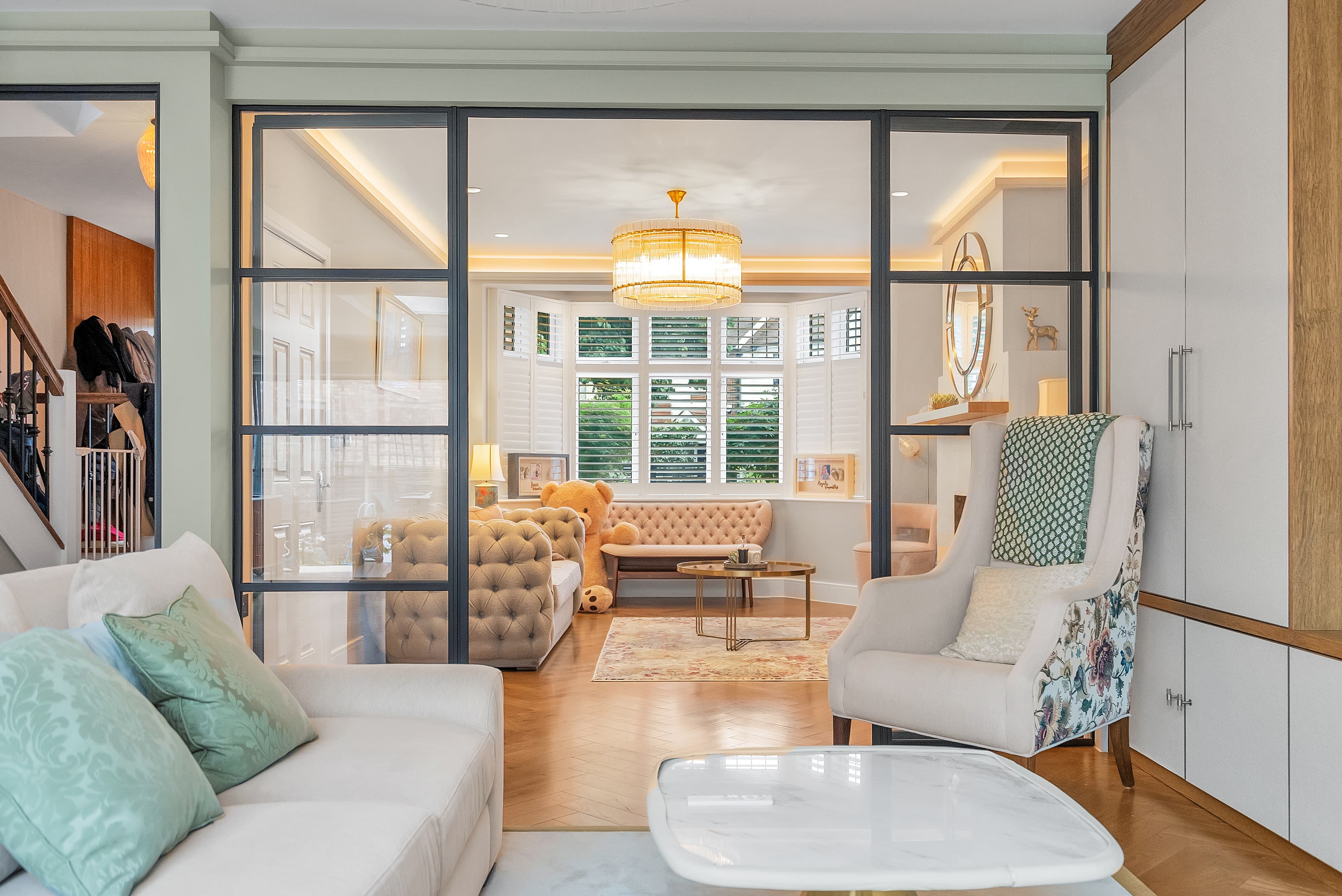 Living spaces connected via Crittall-style glass partitions