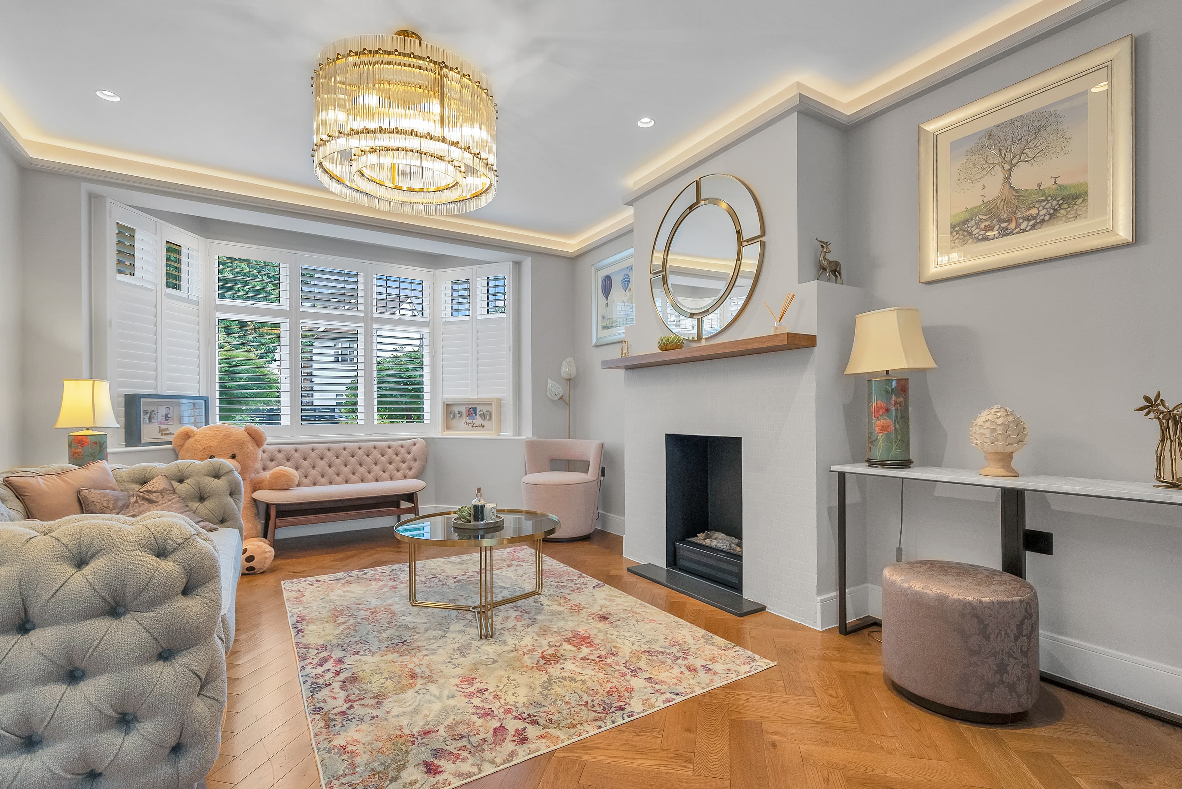 Formal living room with bay window and tufted sofas