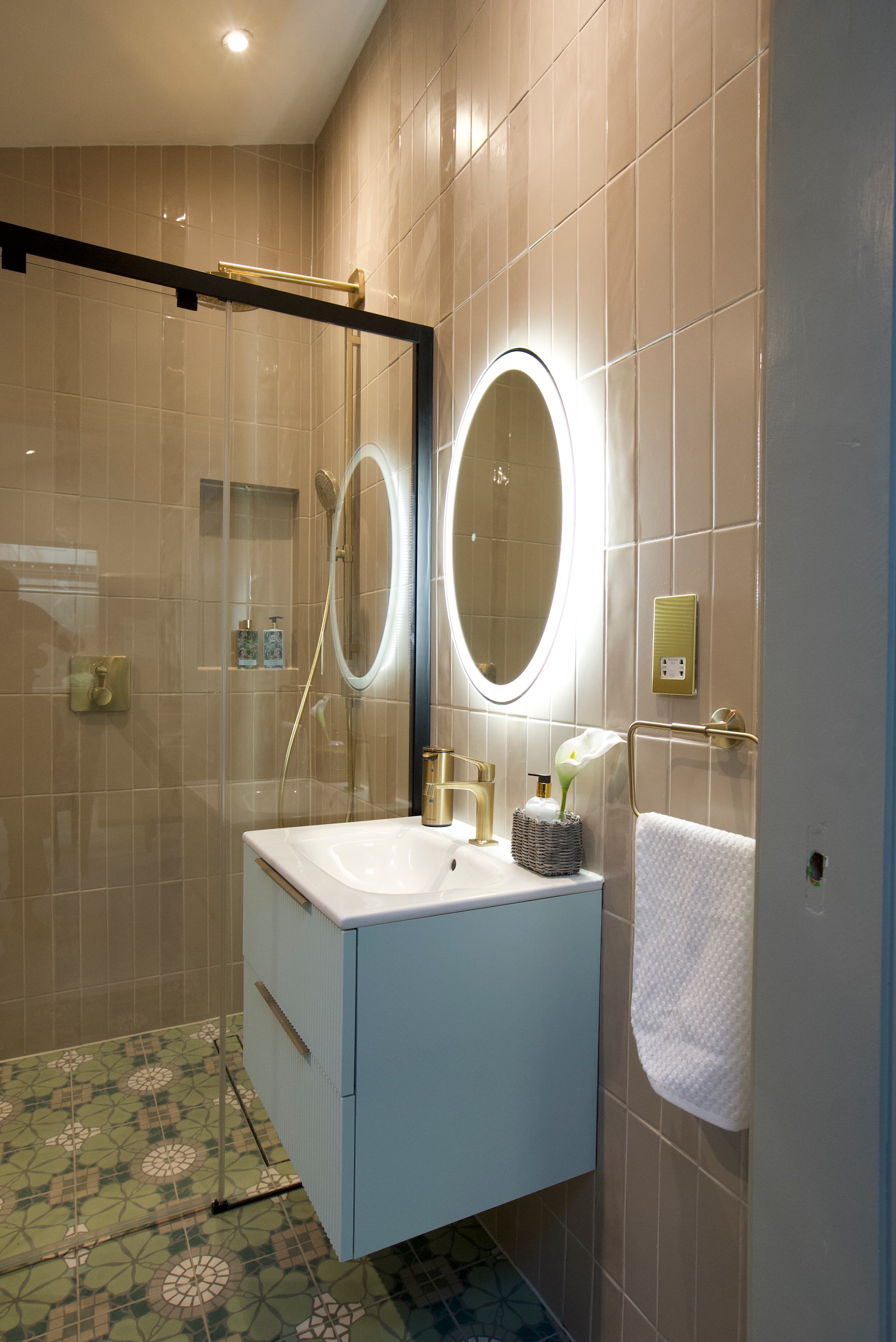 Bathroom with Moroccan floor tiles and brass fixtures