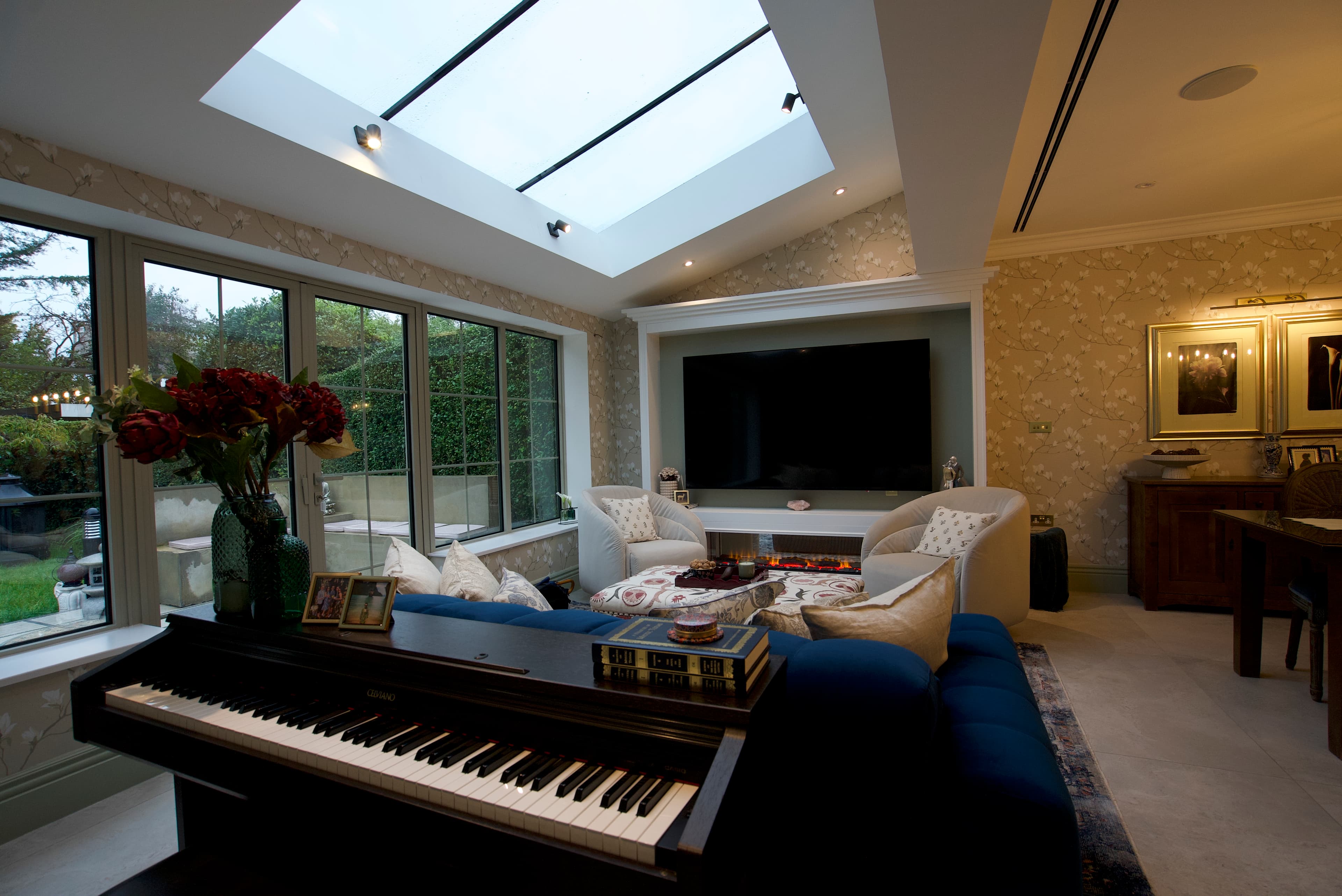 Garden room with linear fireplace and grand piano