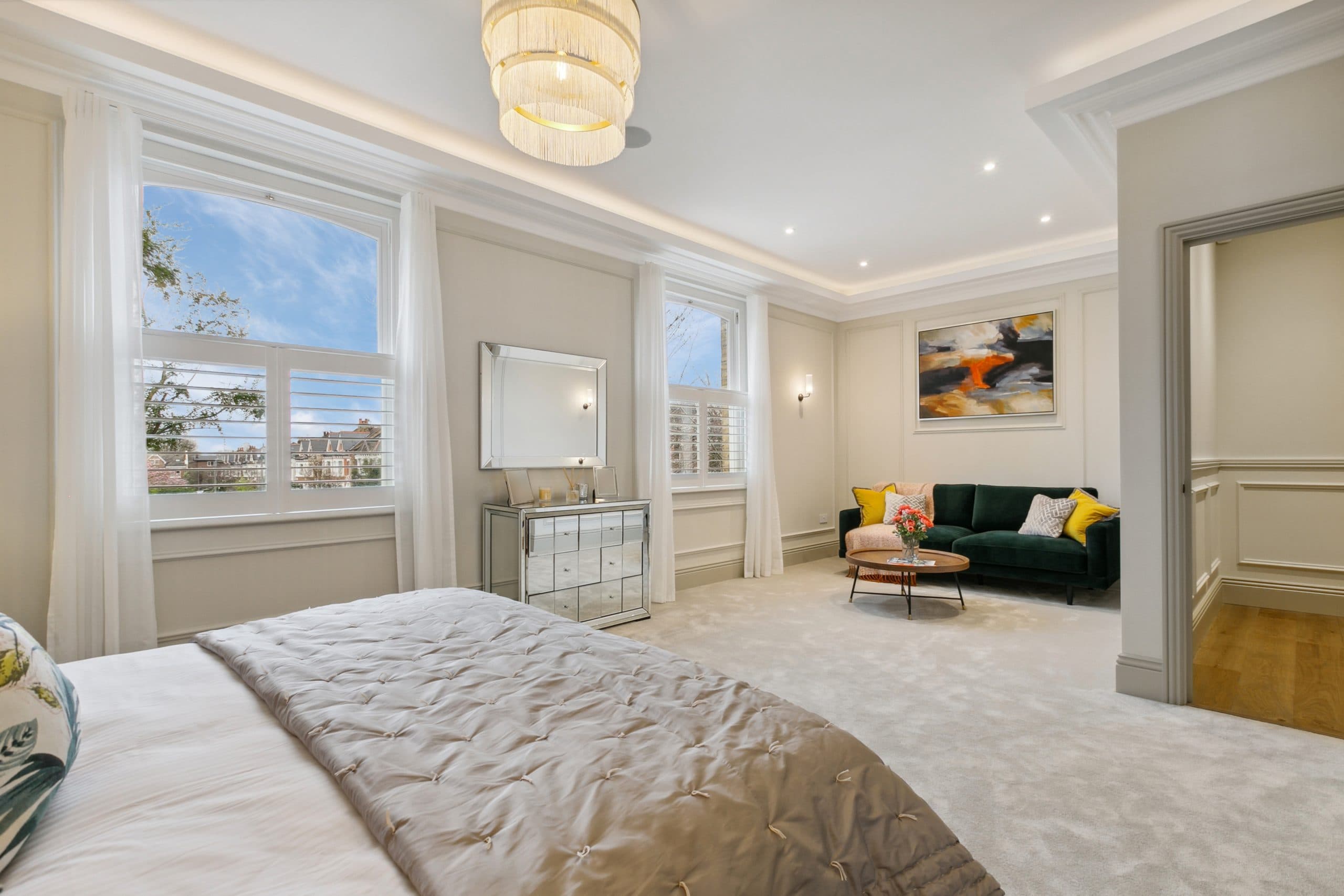 Master bedroom with velvet sofa and silk drapery