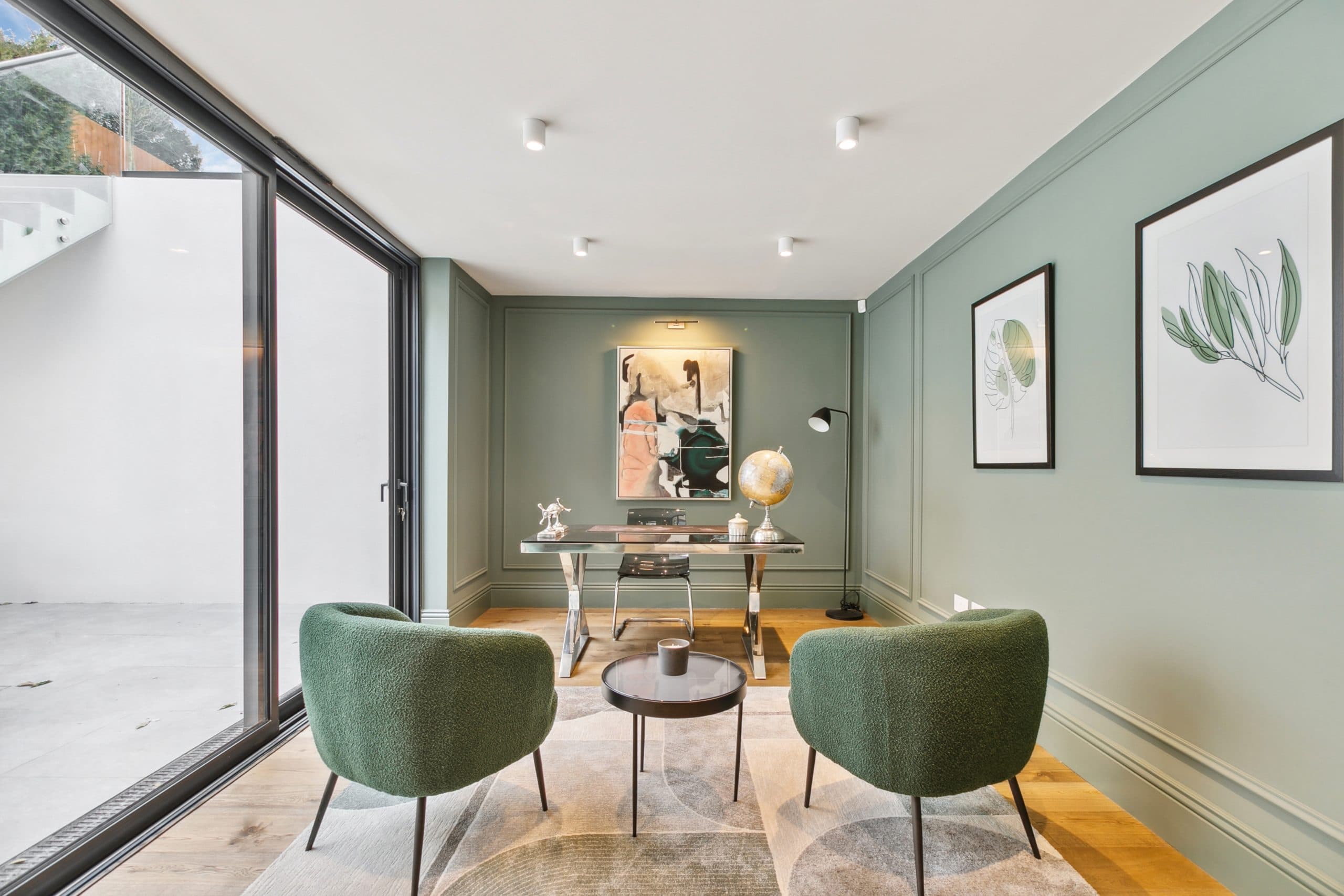 Private study with sage walls and garden views