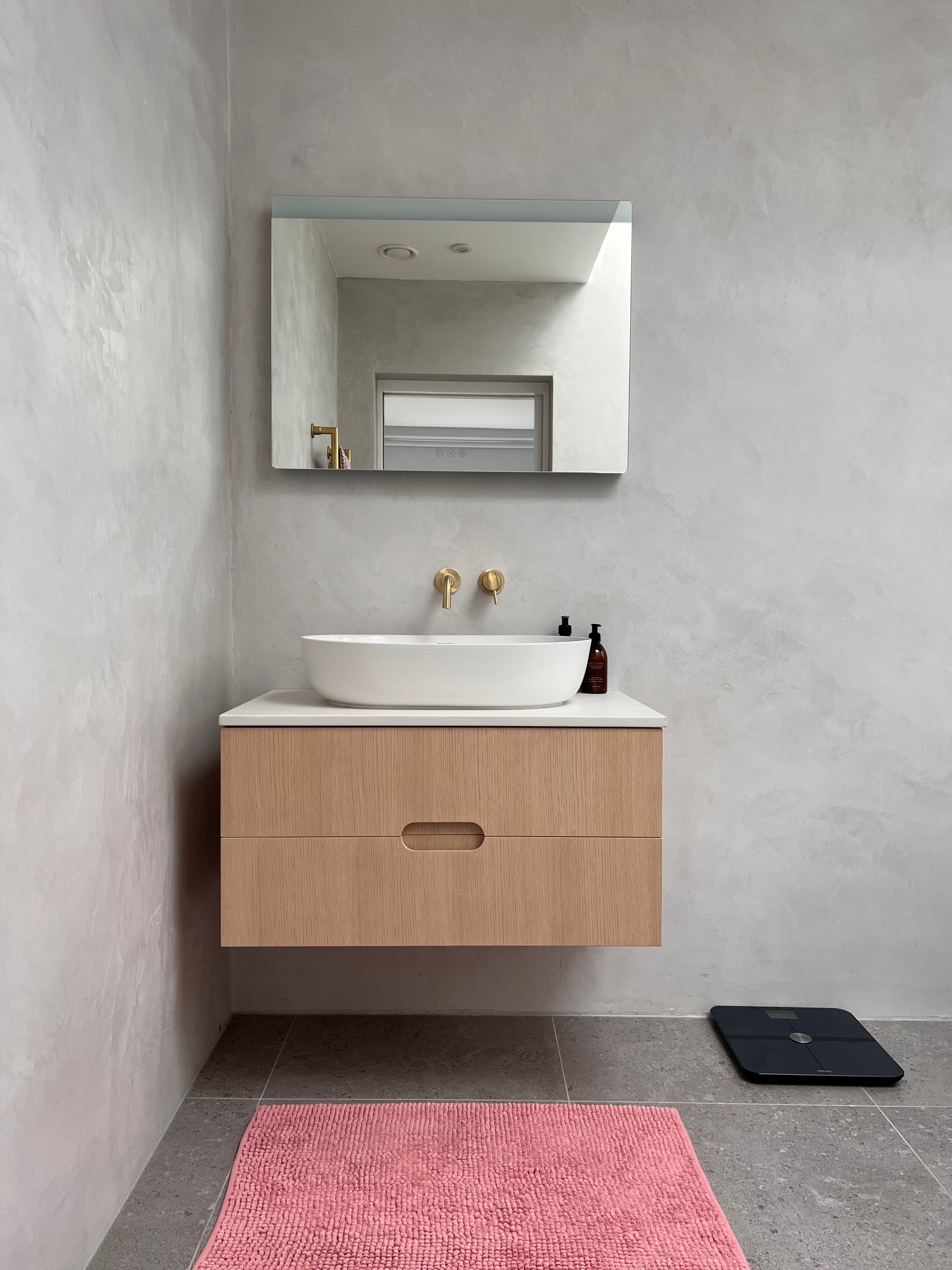 Floating oak vanity with microcement walls