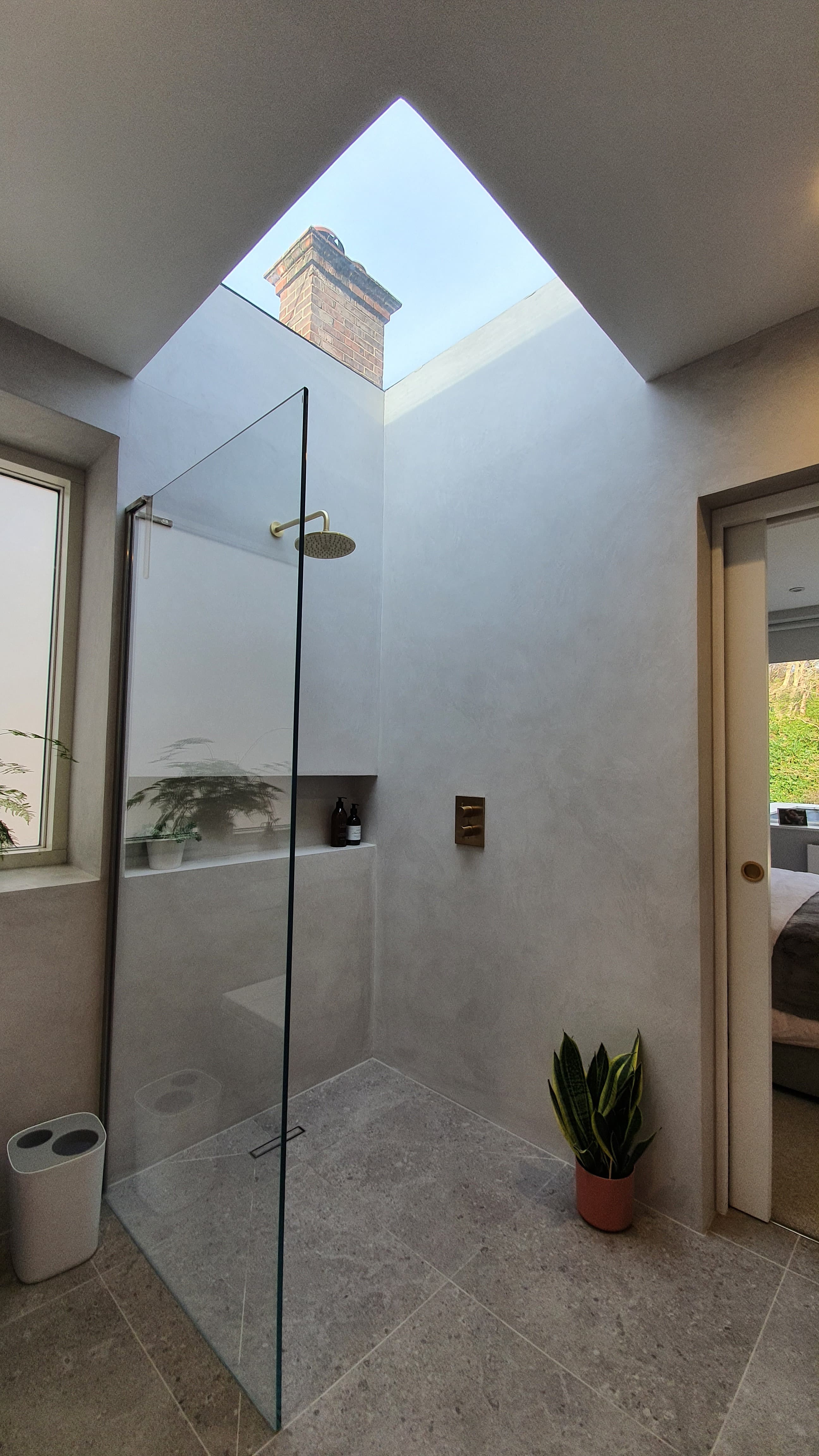 En-suite with microcement walls and dramatic rooflight