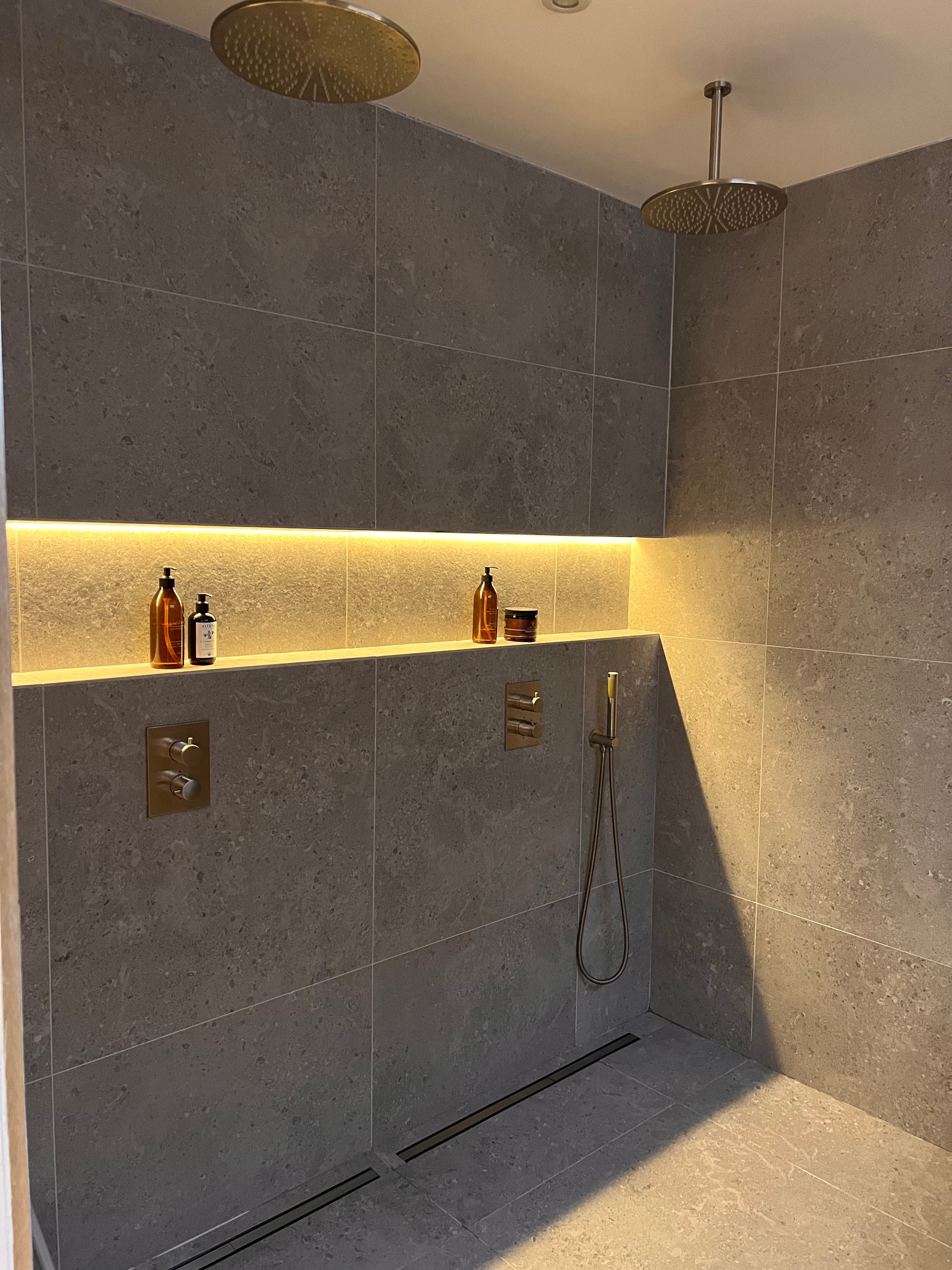 Dual rainfall shower with brass fixtures and LED niche